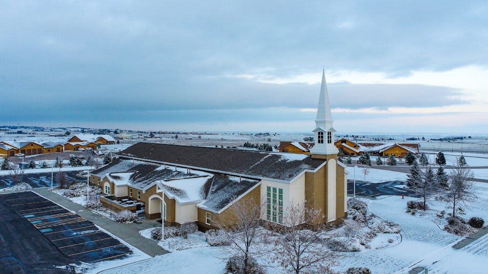 a building with a steeple and a snowy landscape