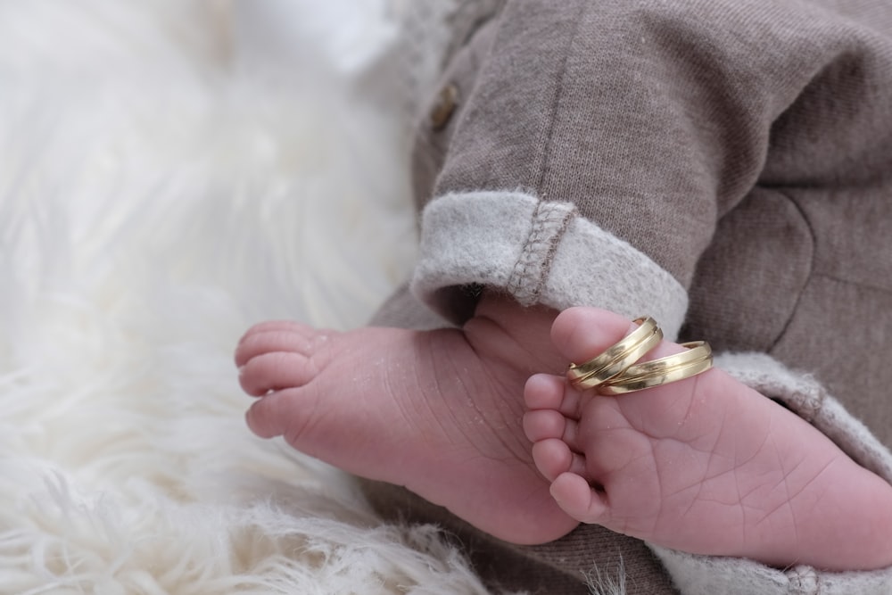 a person holding a small gold object