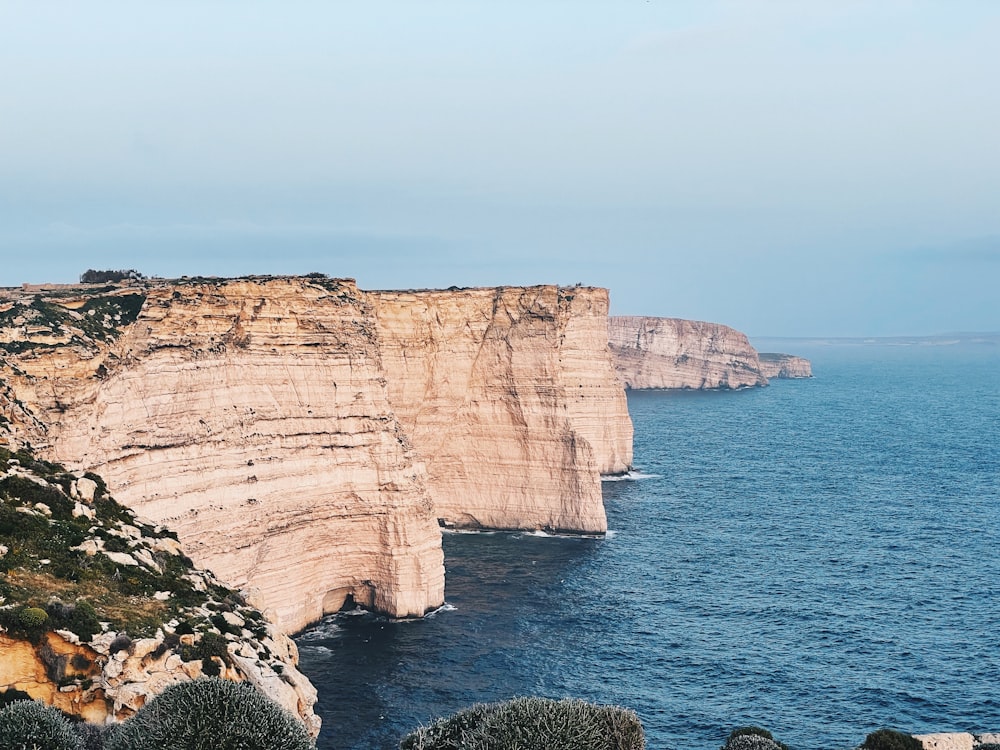 a cliff next to the water