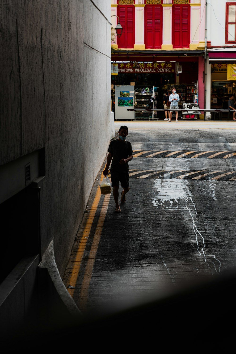 a person walking down a wet street