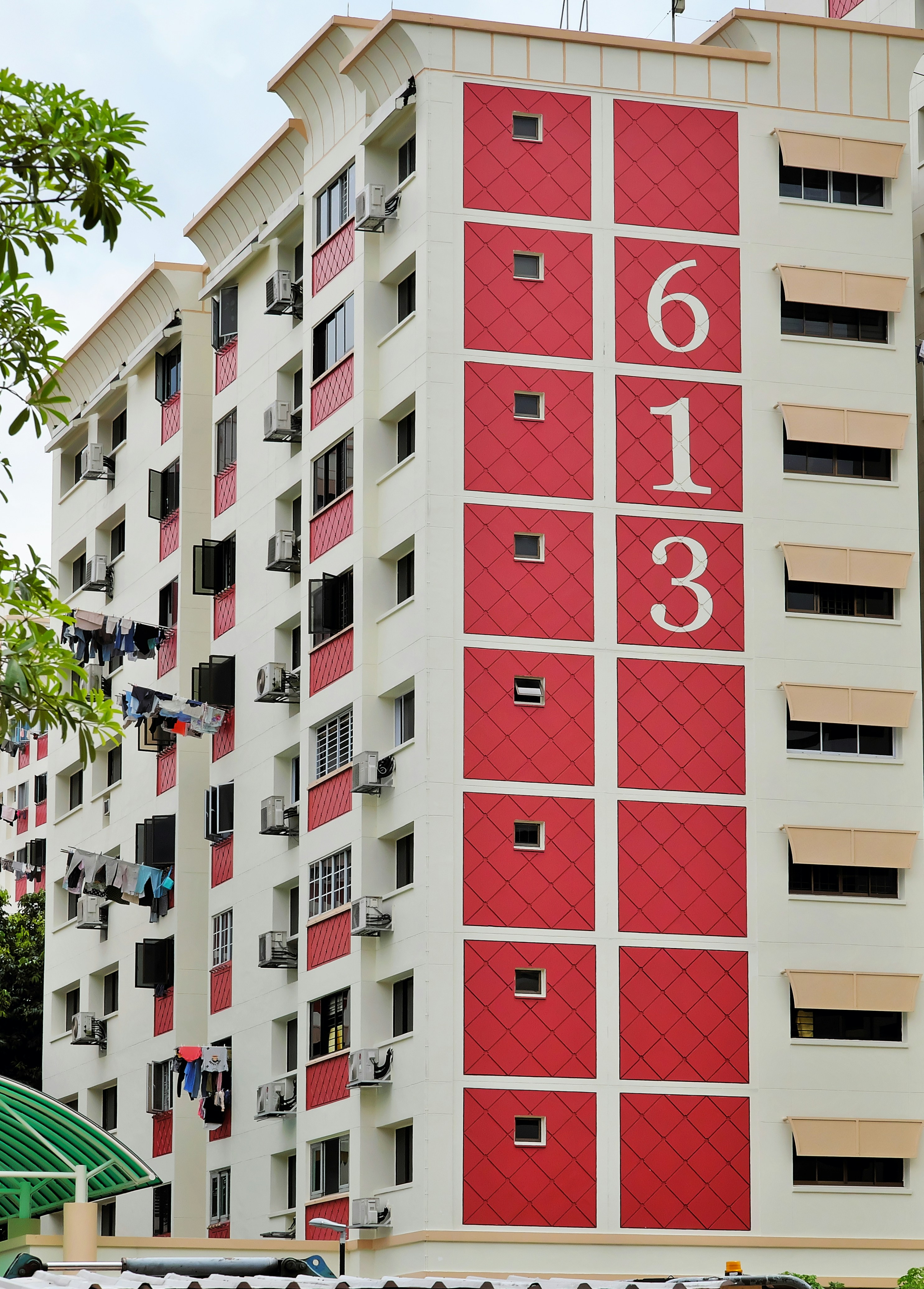 a tall white building with a sign on it