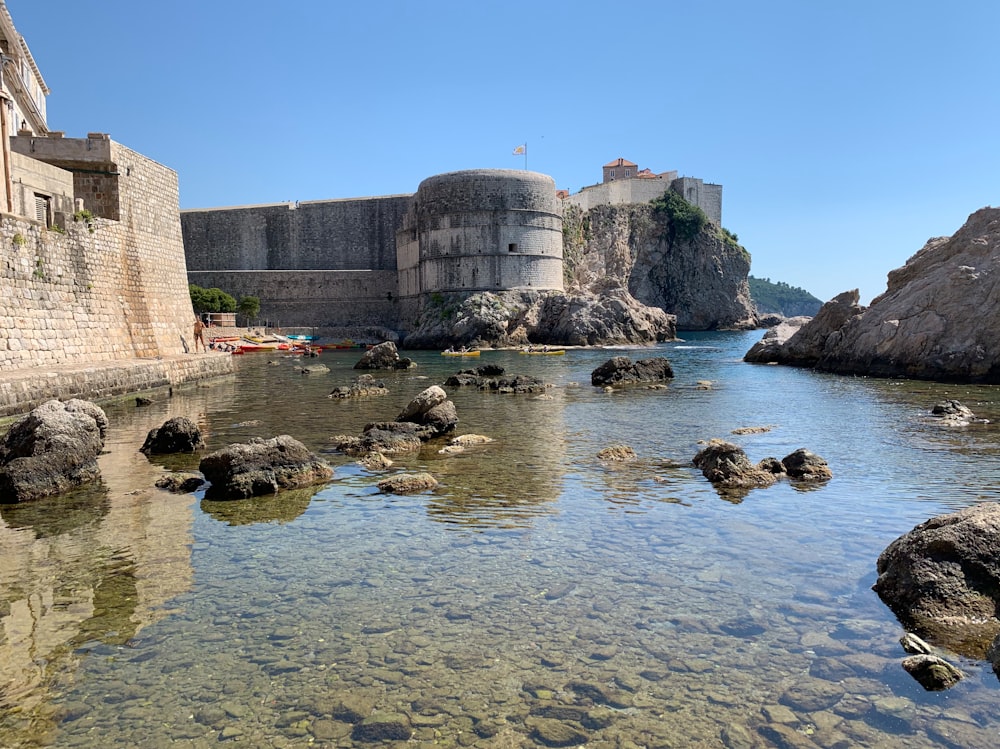 a stone castle on a rocky beach