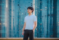 A confident individual looking at a city skyline from a high vantage point.