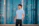 Portrait of a confident young professional smiling with a modern cityscape background.