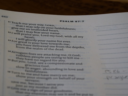 A page from a religious text showing Psalm 87:7, printed in clear black text on white paper. The verses discuss faithfulness and reliance on divine strength. The page is slightly curved, and there is marginal writing.