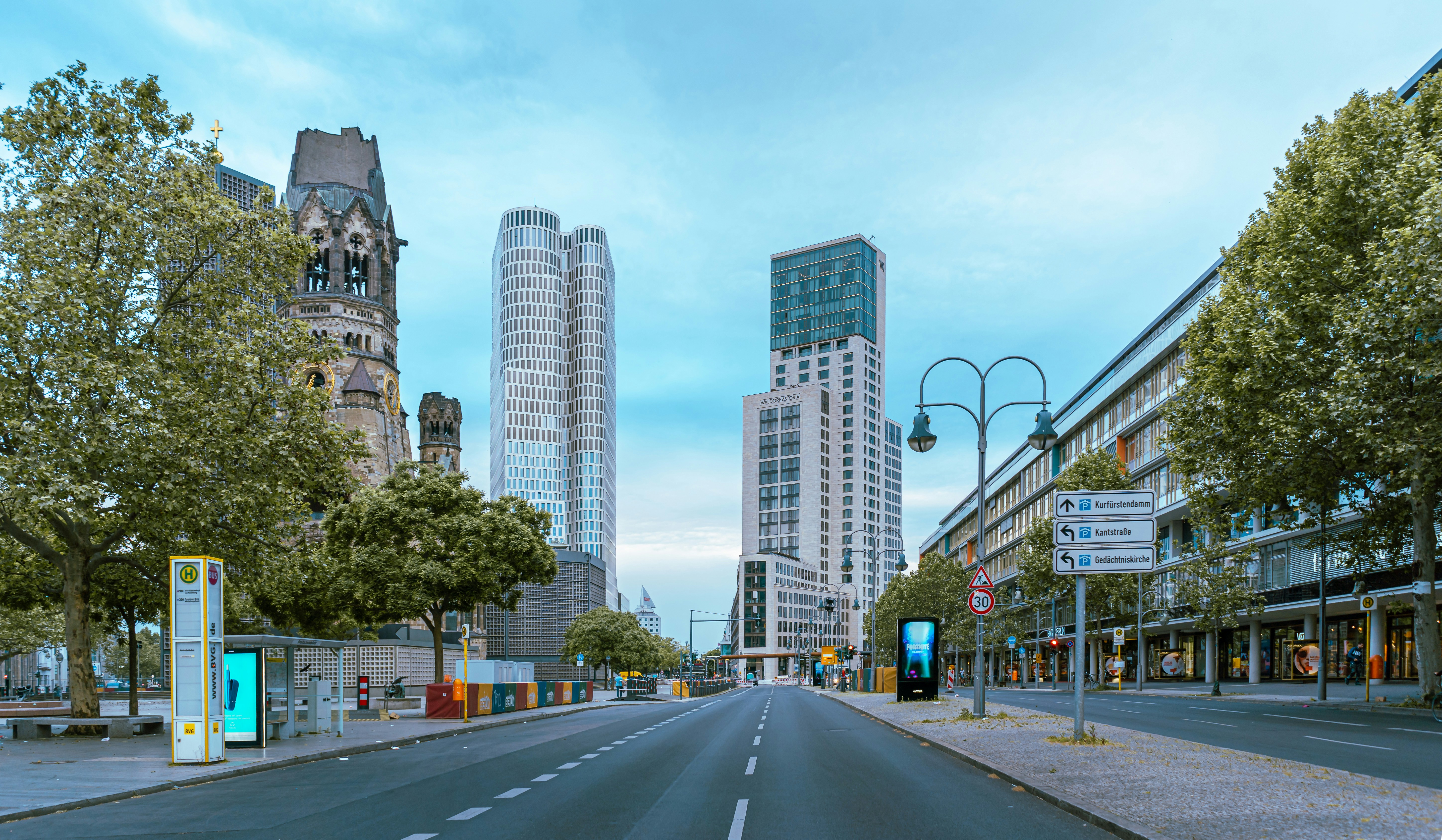 a street with trees and buildings on the side