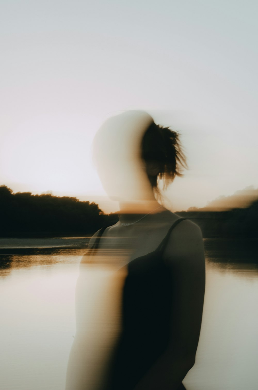 a person standing in front of a body of water