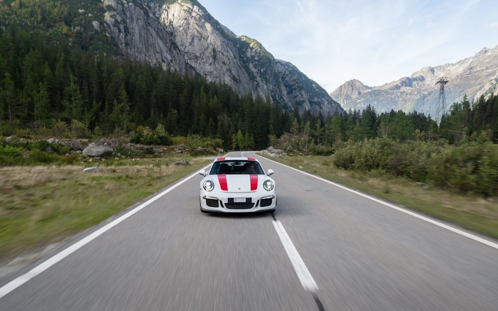 a white car driving on a road