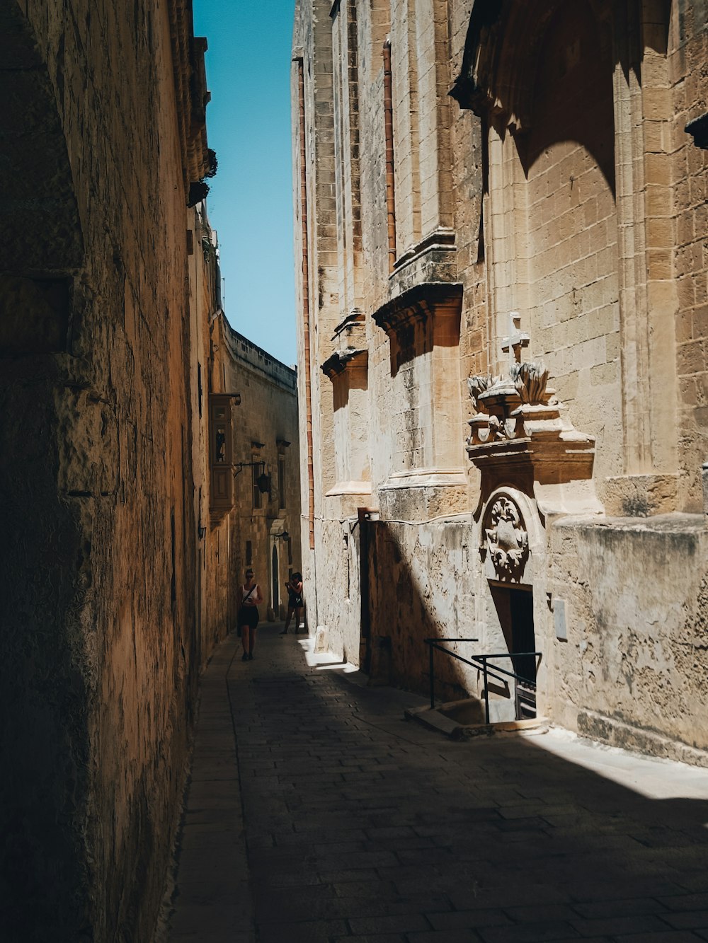 a stone street with buildings on both sides