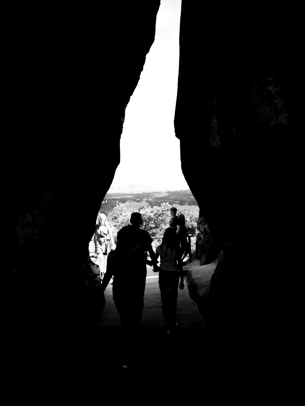 people standing in a cave