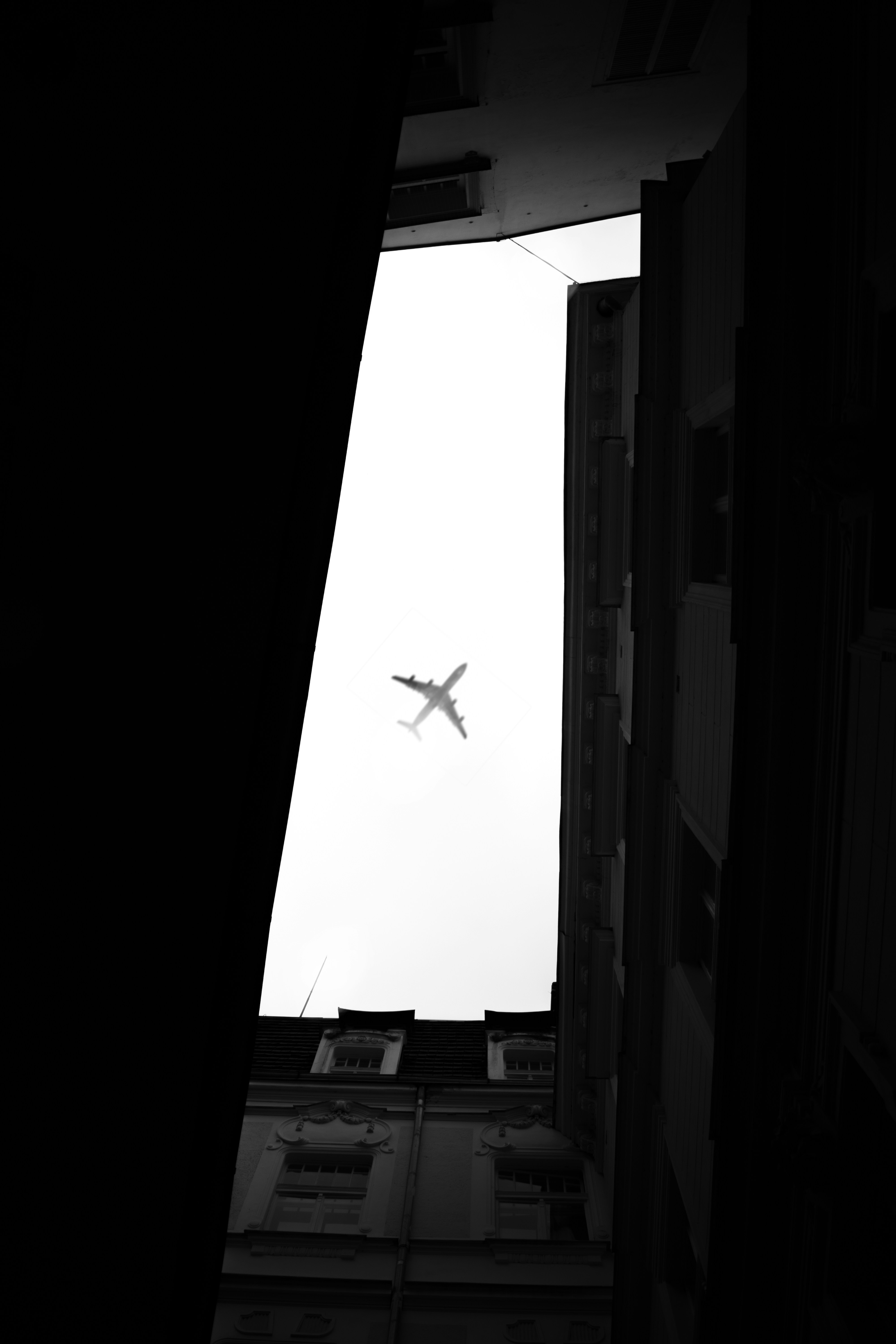 a plane flying over buildings