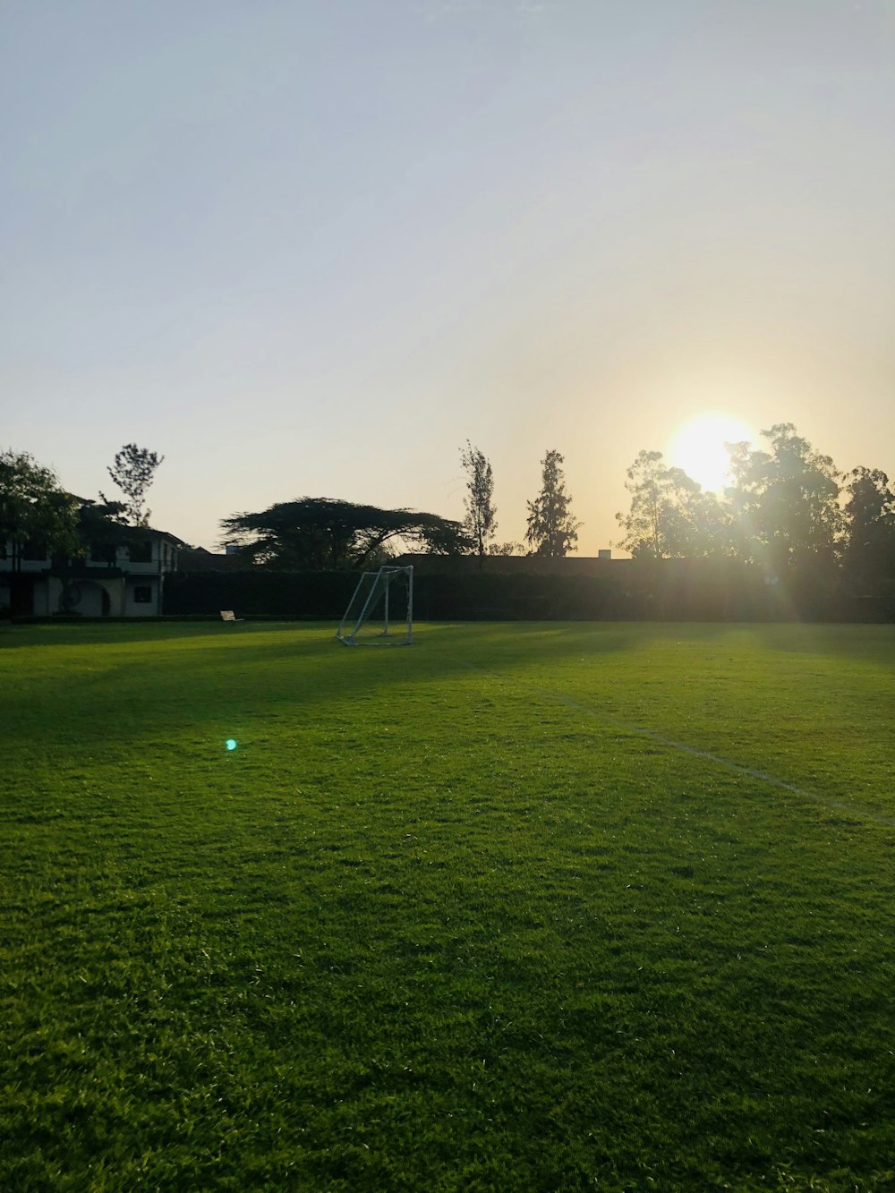 a grassy field with a swing set