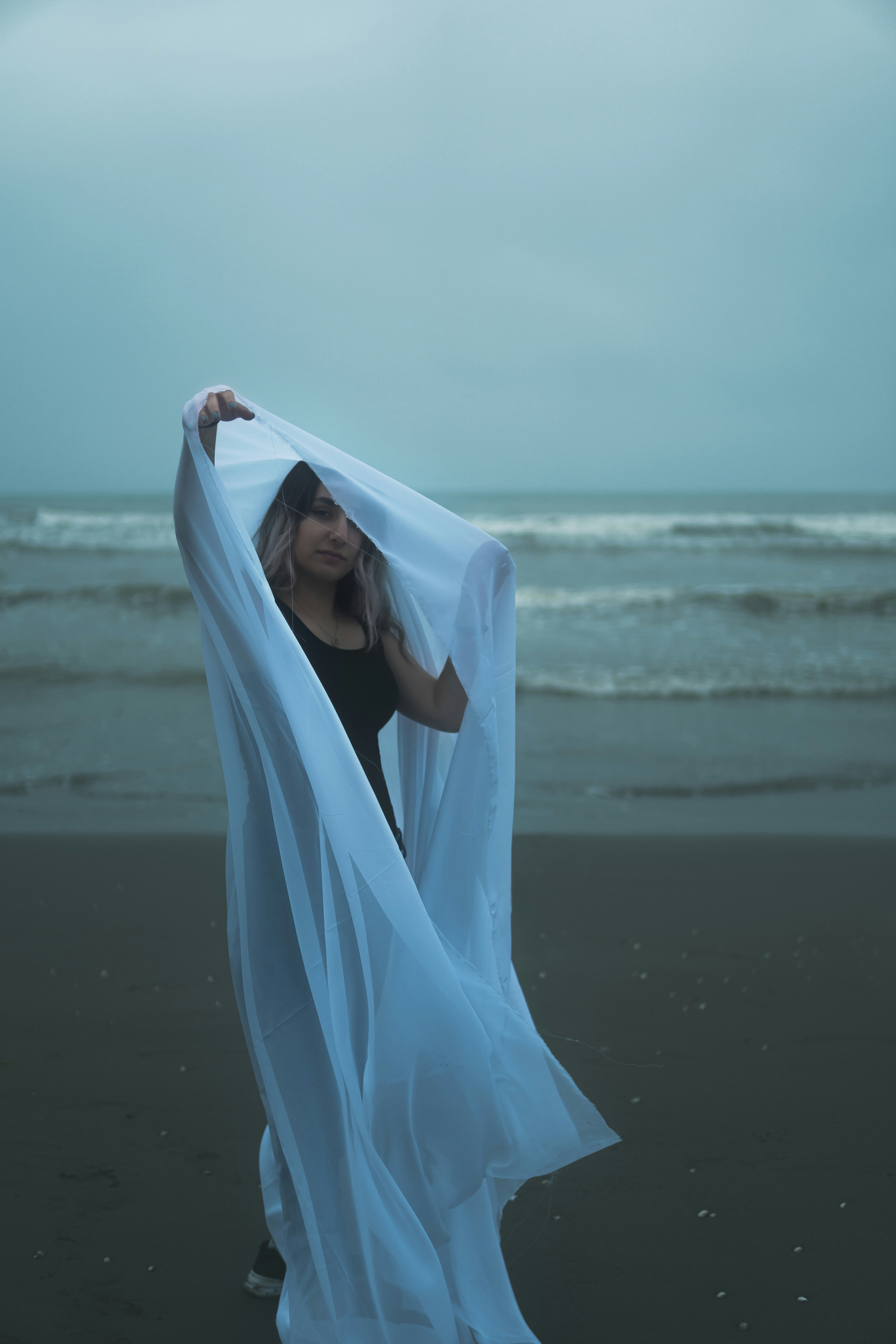 A person in a white dress on a beach