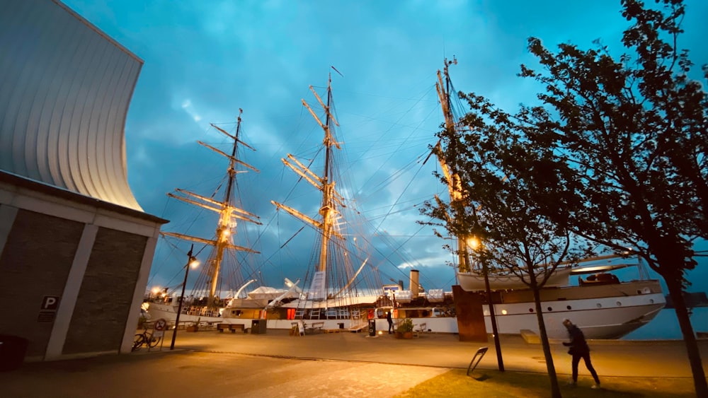 a large sailboat docked at a pier