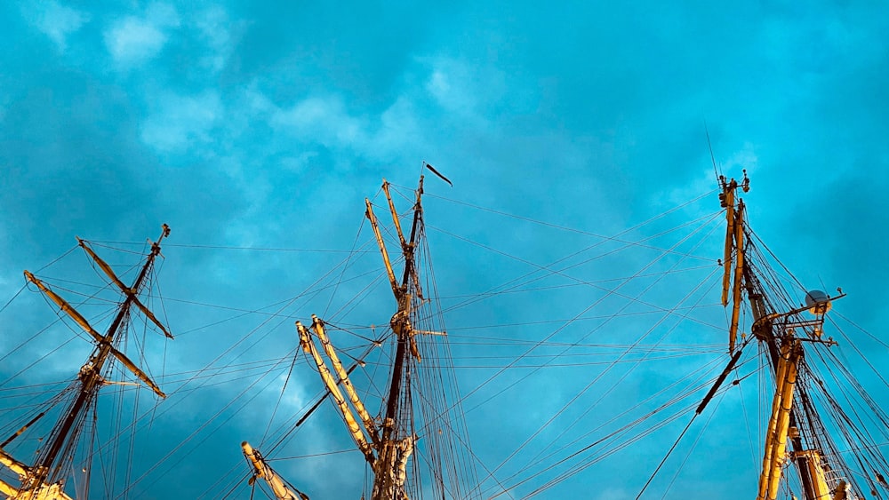 a group of tall wooden masts