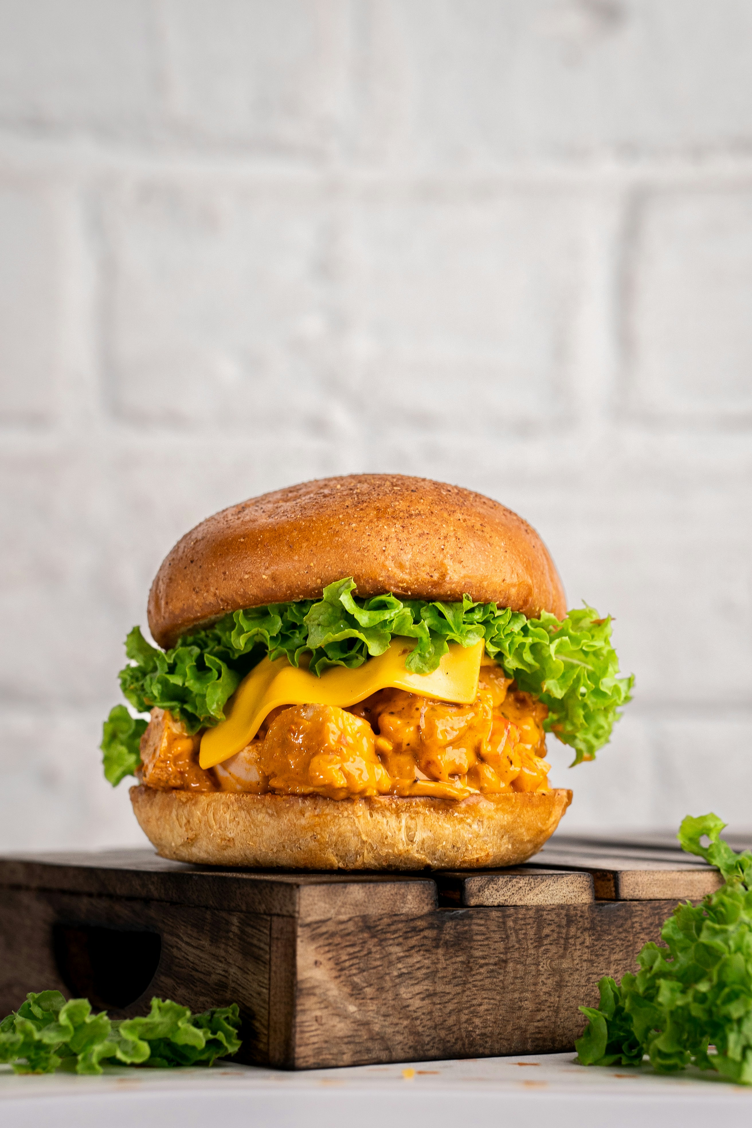 a cheeseburger on a wooden board