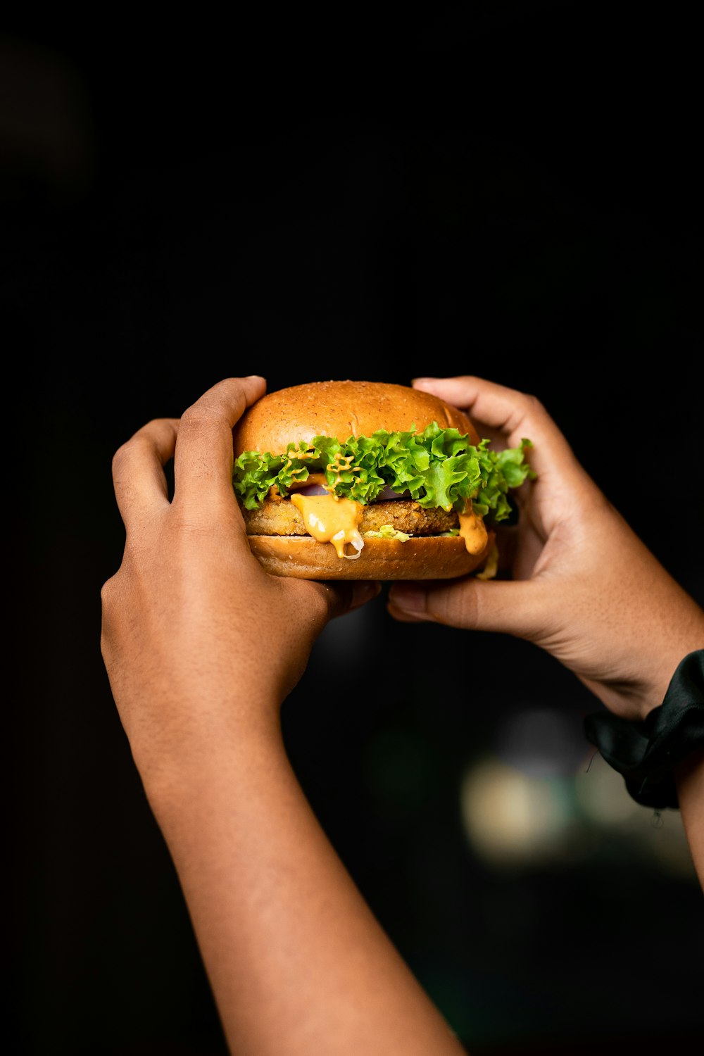 a person holding a burger