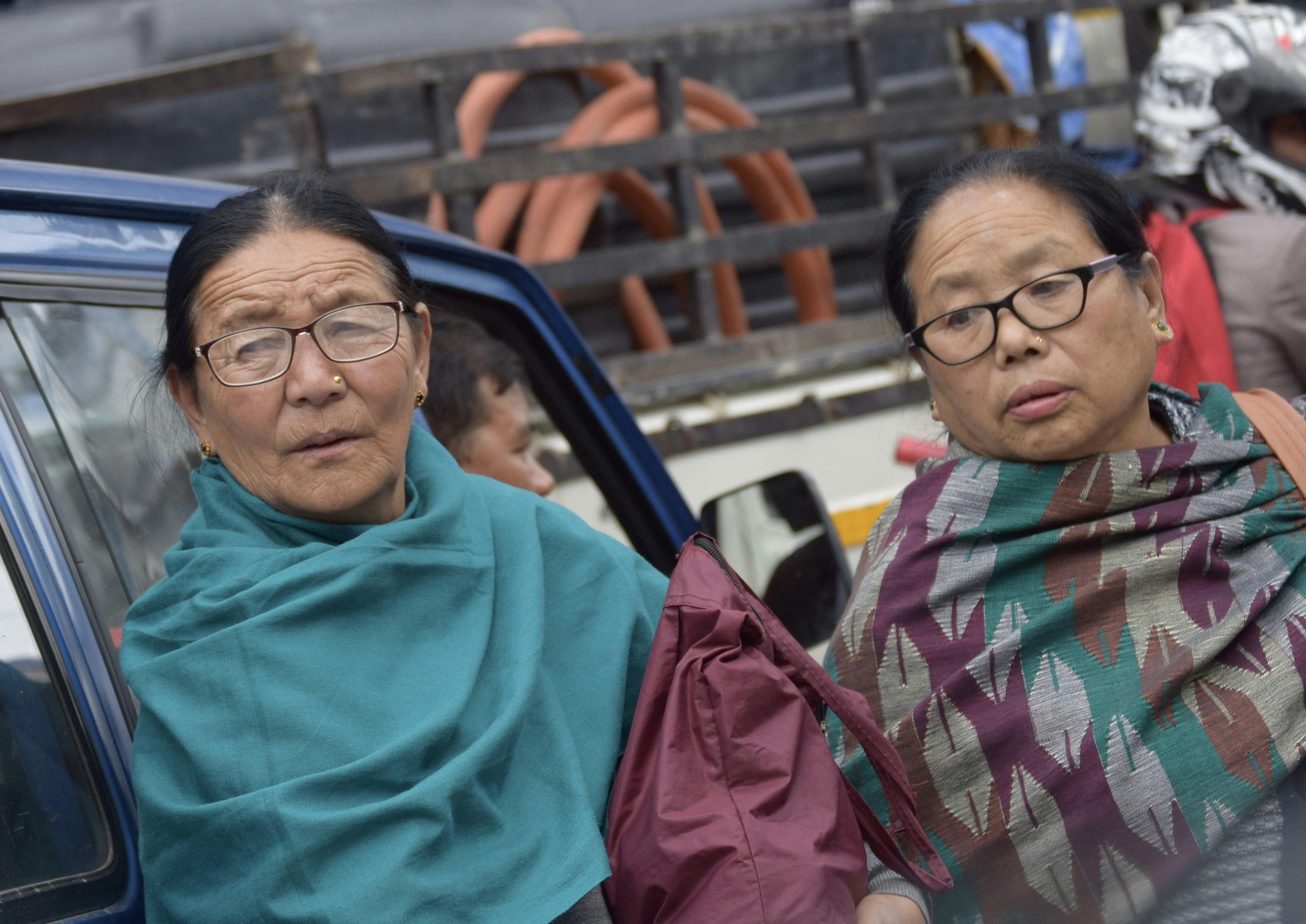A split image showing Mamata Banerjee and Abhishek Banerjee on one side, and a few BJP leaders including Suvendu Adhikari on the other, symbolizing the political divide.