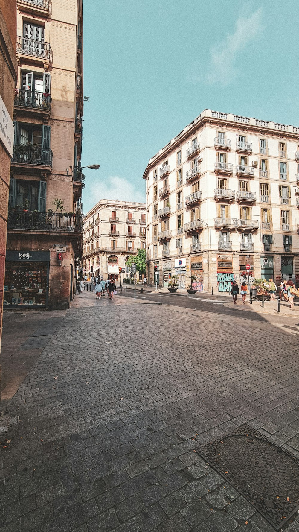 a cobblestone street between buildings