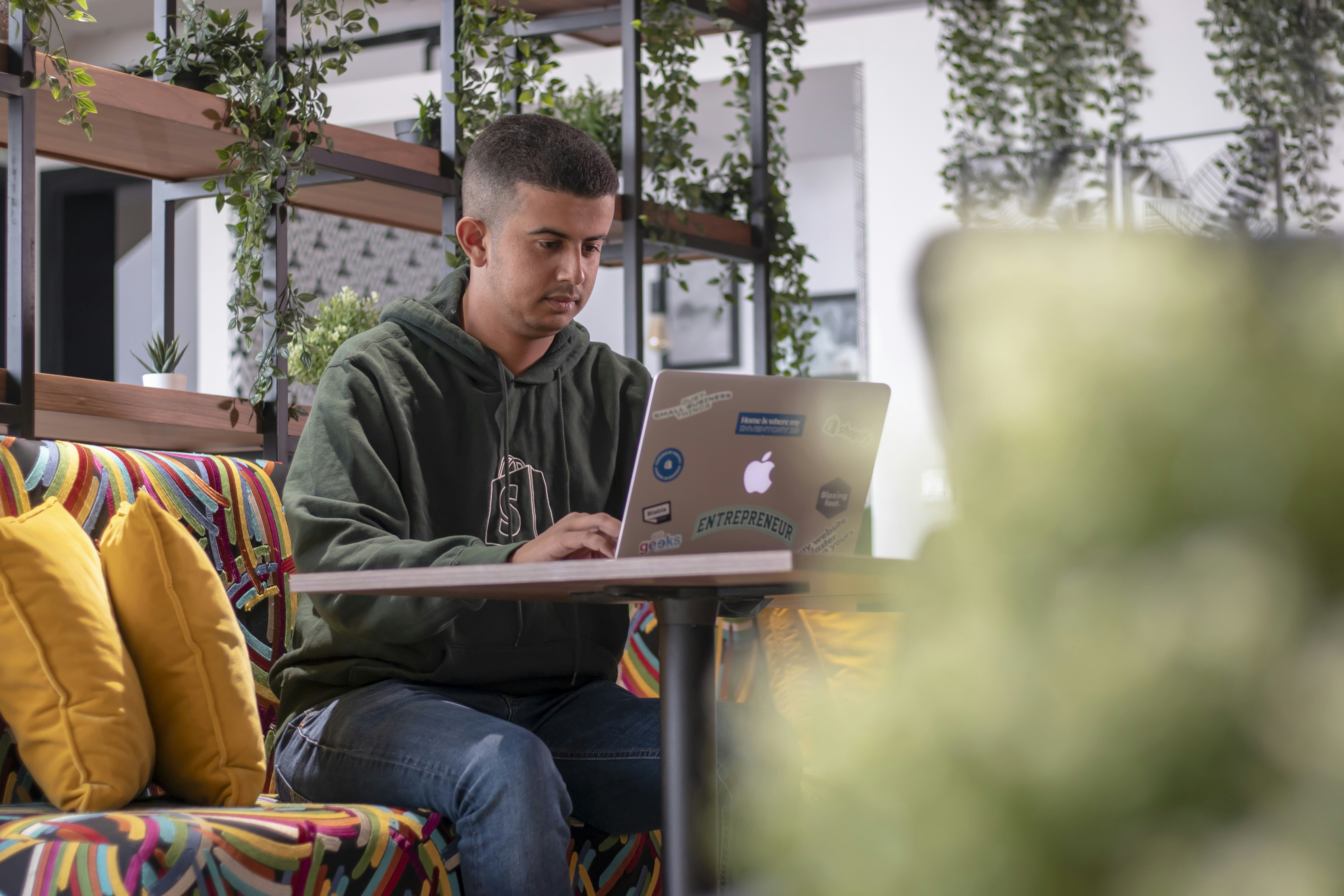 a man sitting on a couch with a laptop