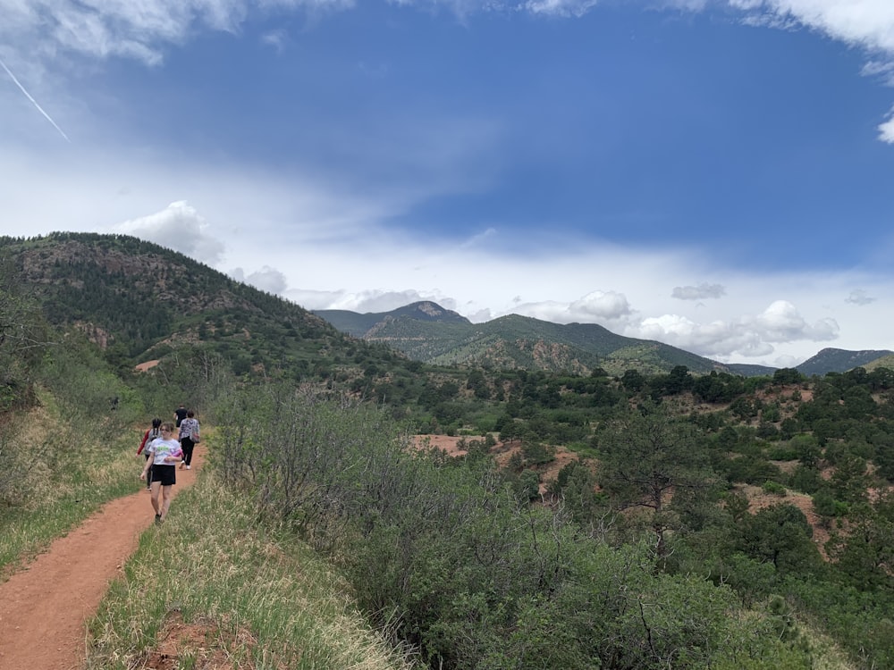 a group of people hiking in the mountains