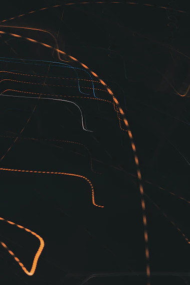 Close-up of a vibrant orange fluid graphic on a dark background, showcasing dynamic brush strokes.