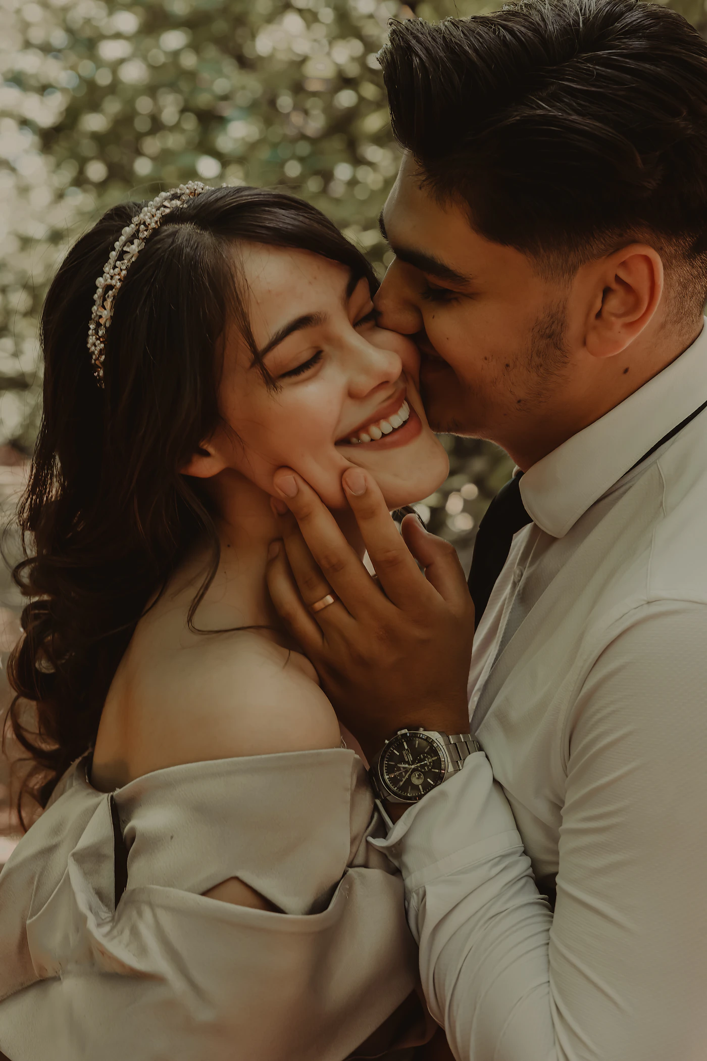 Wedding couple in an intimate close moment with faces almost touching and soft warm natural light across their faces
