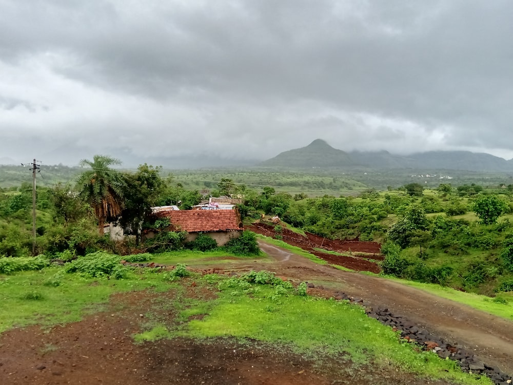 a dirt road leading to a house