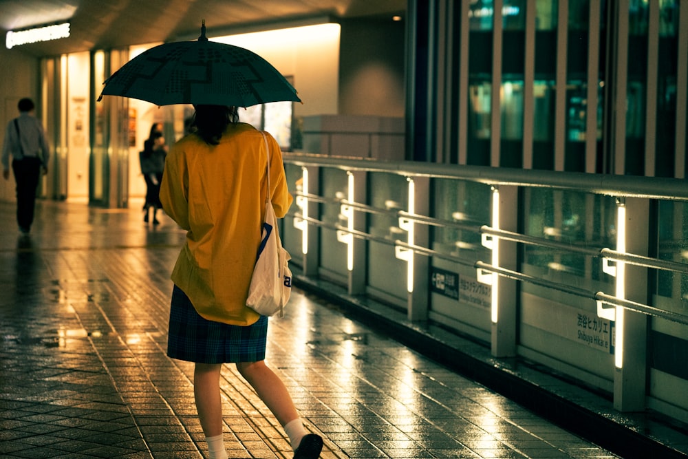 a person walking in the rain holding an umbrella