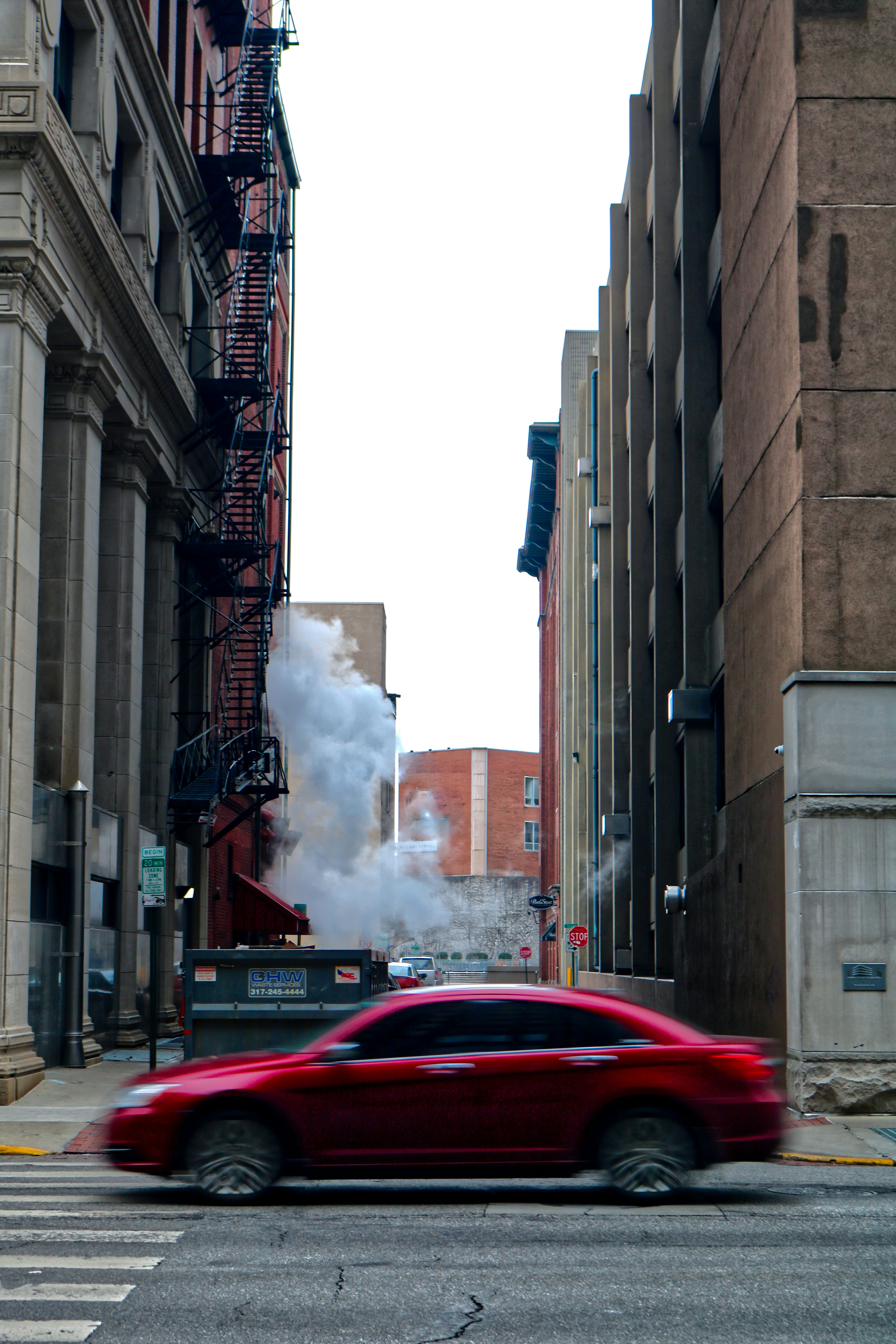 a car on a street with a fire coming out of the back