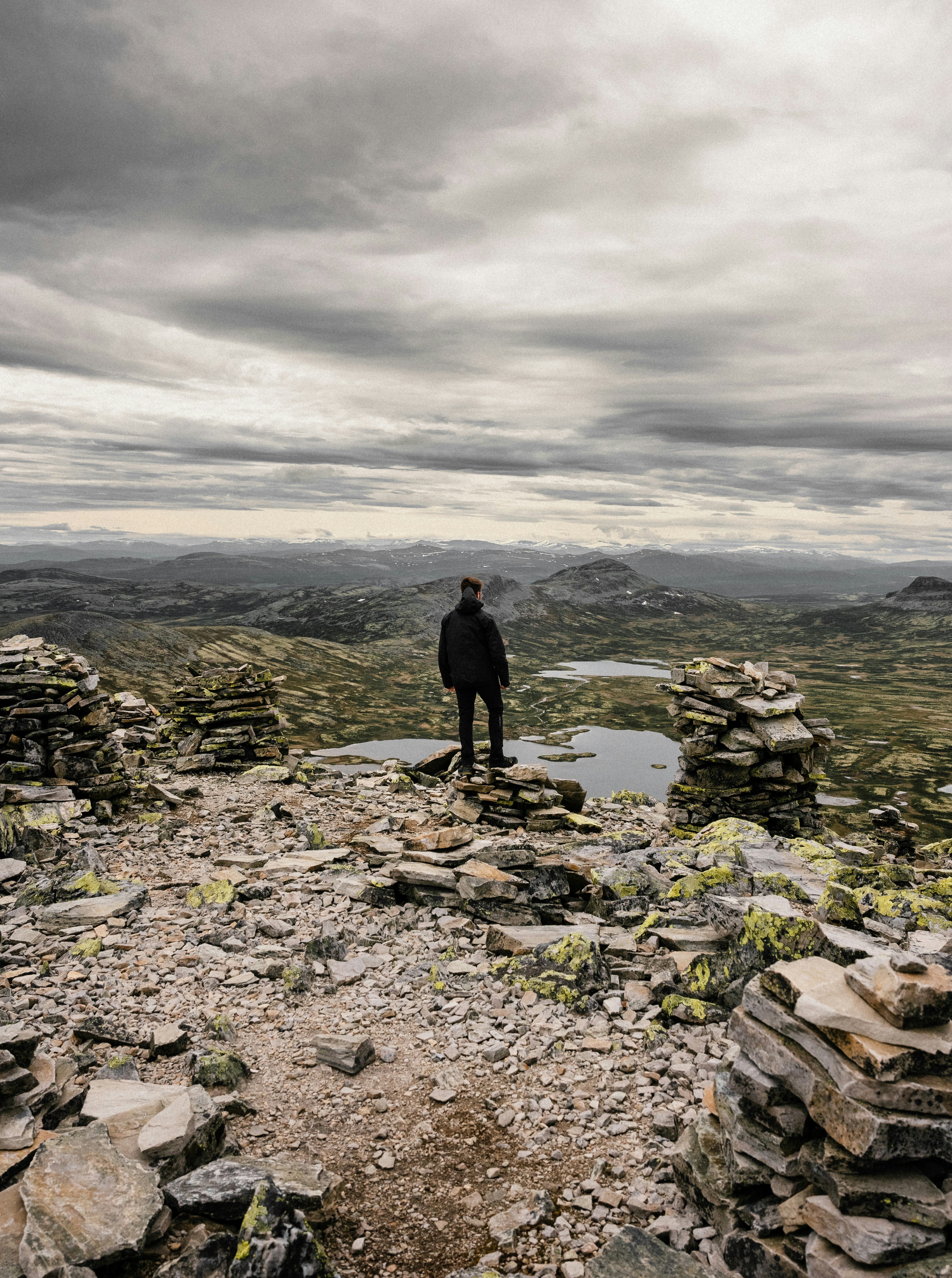a man standing on a rocky hillside