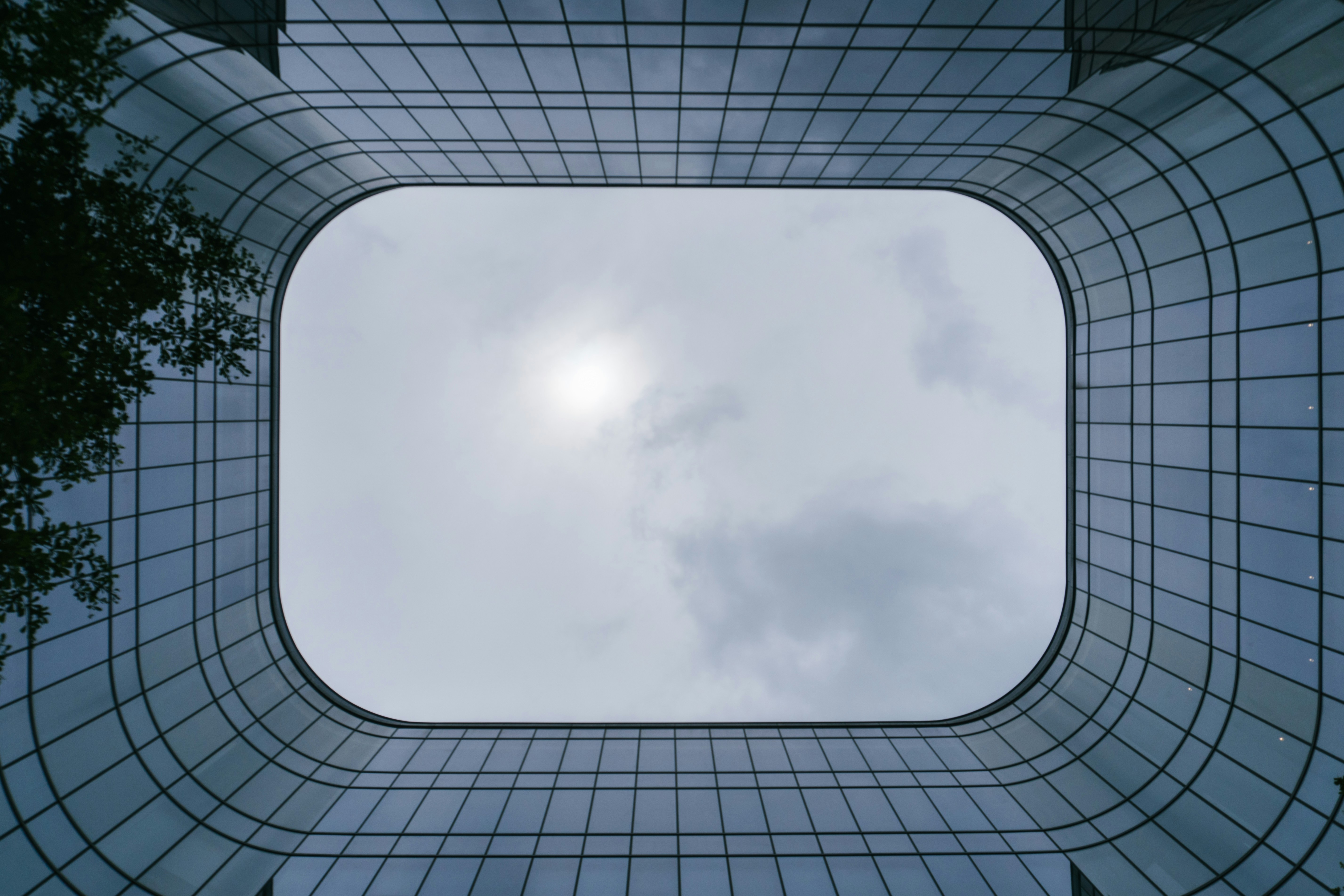a circular window with a cloudy sky
