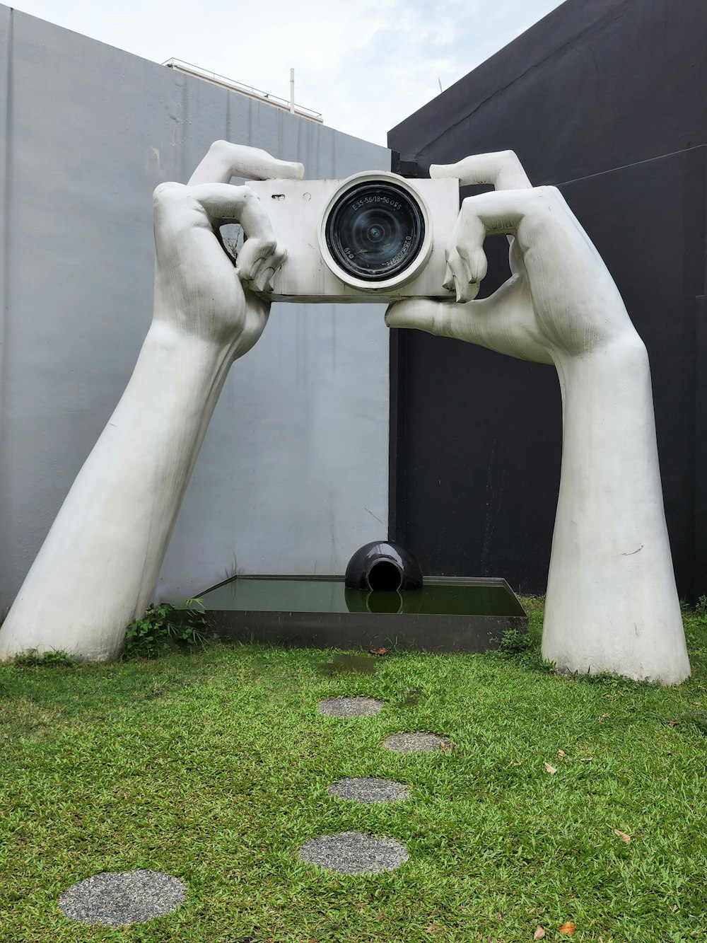 a statue of a person holding a camera