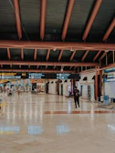Friendly travel guides assisting pilgrims with smiles at the airport departure lounge