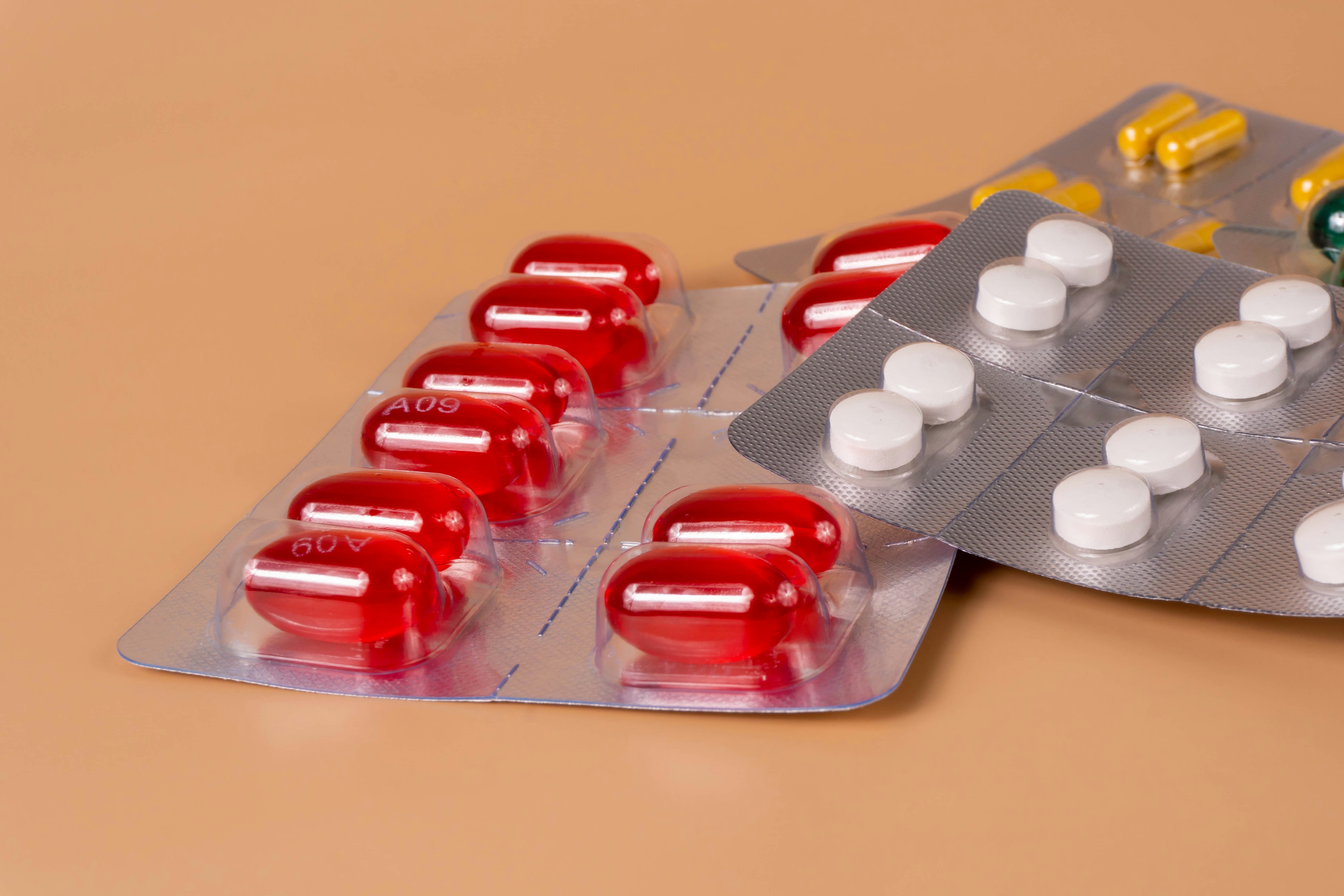 Pill packs on a pastel background.