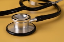 A close-up of a stethoscope on a doctor's desk.