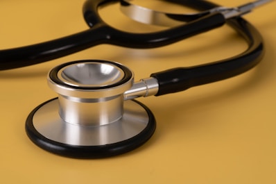 Close-up of a high-quality stethoscope on a wooden desk
