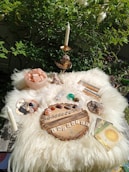 An altar set with ritual tools, herbs, and crystals under a warm, inviting light.