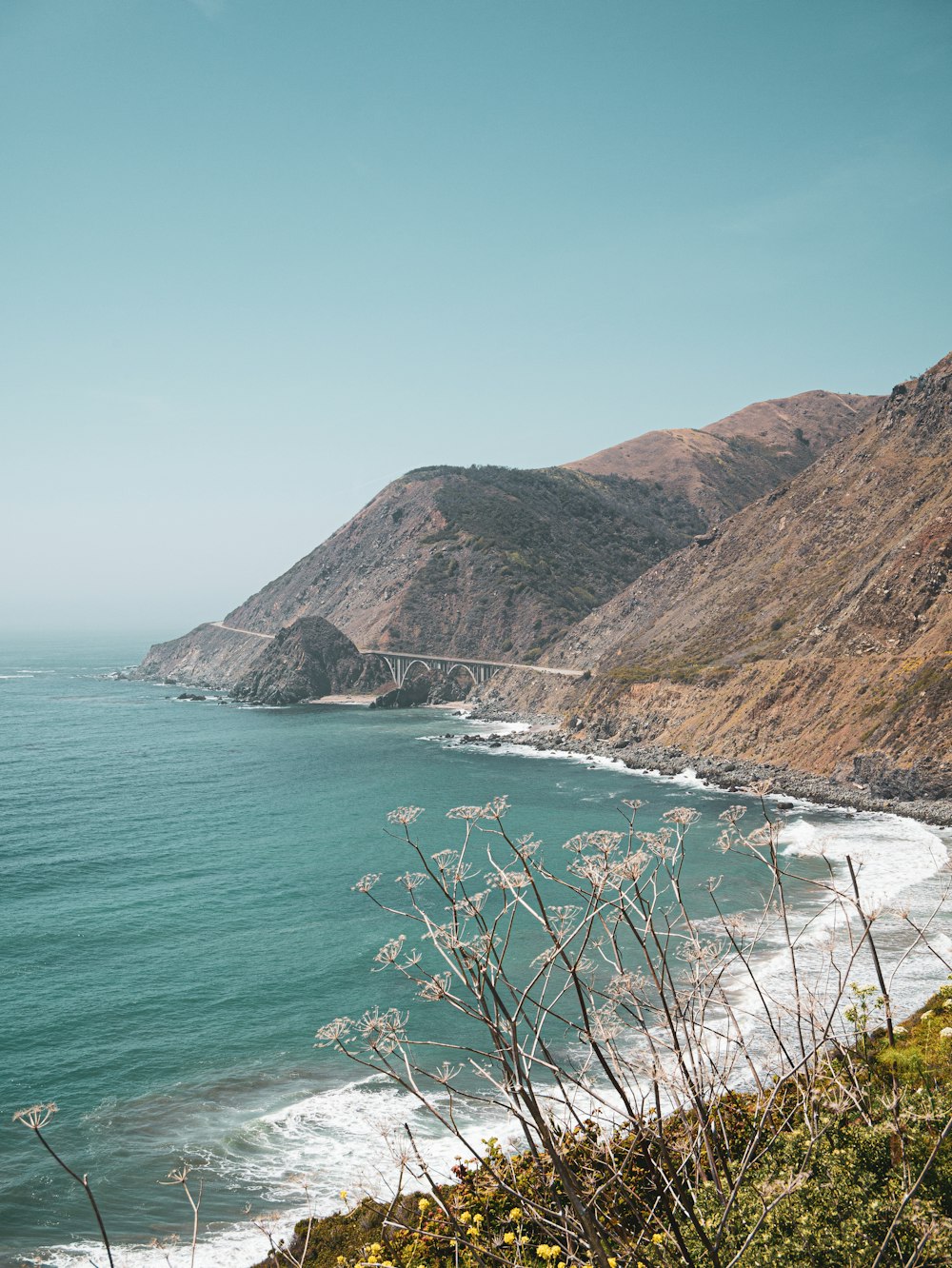 a body of water with hills in the background