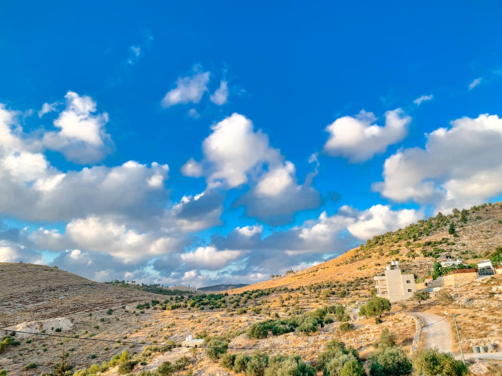 a landscape with hills and buildings