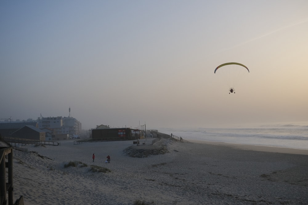 a person flying a kite on a beach