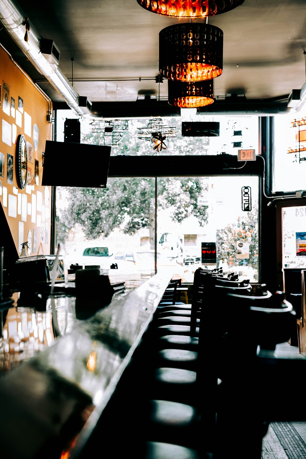 a view of a street through a window of a restaurant