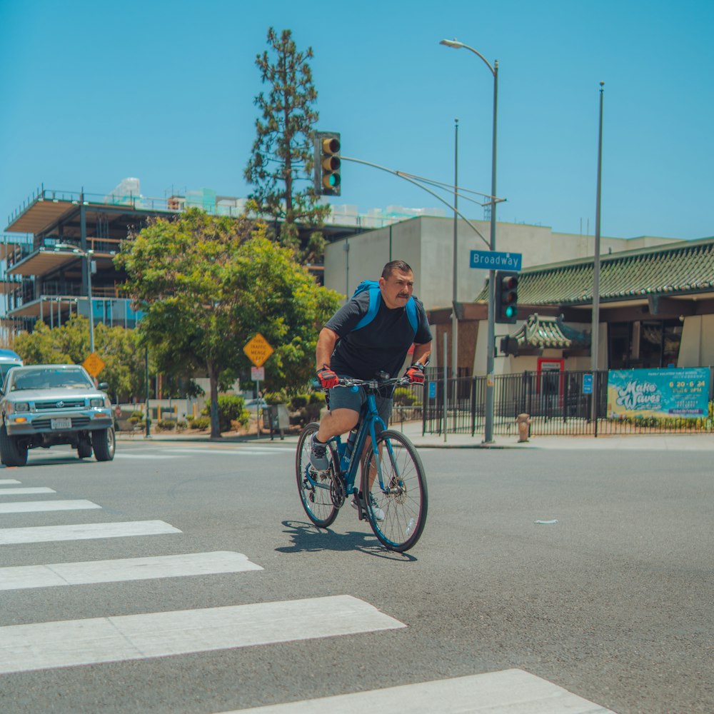 a person riding a bicycle across a crosswalk
