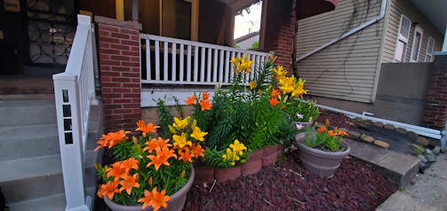 Seasonal flower arrangements brightening a front porch garden.