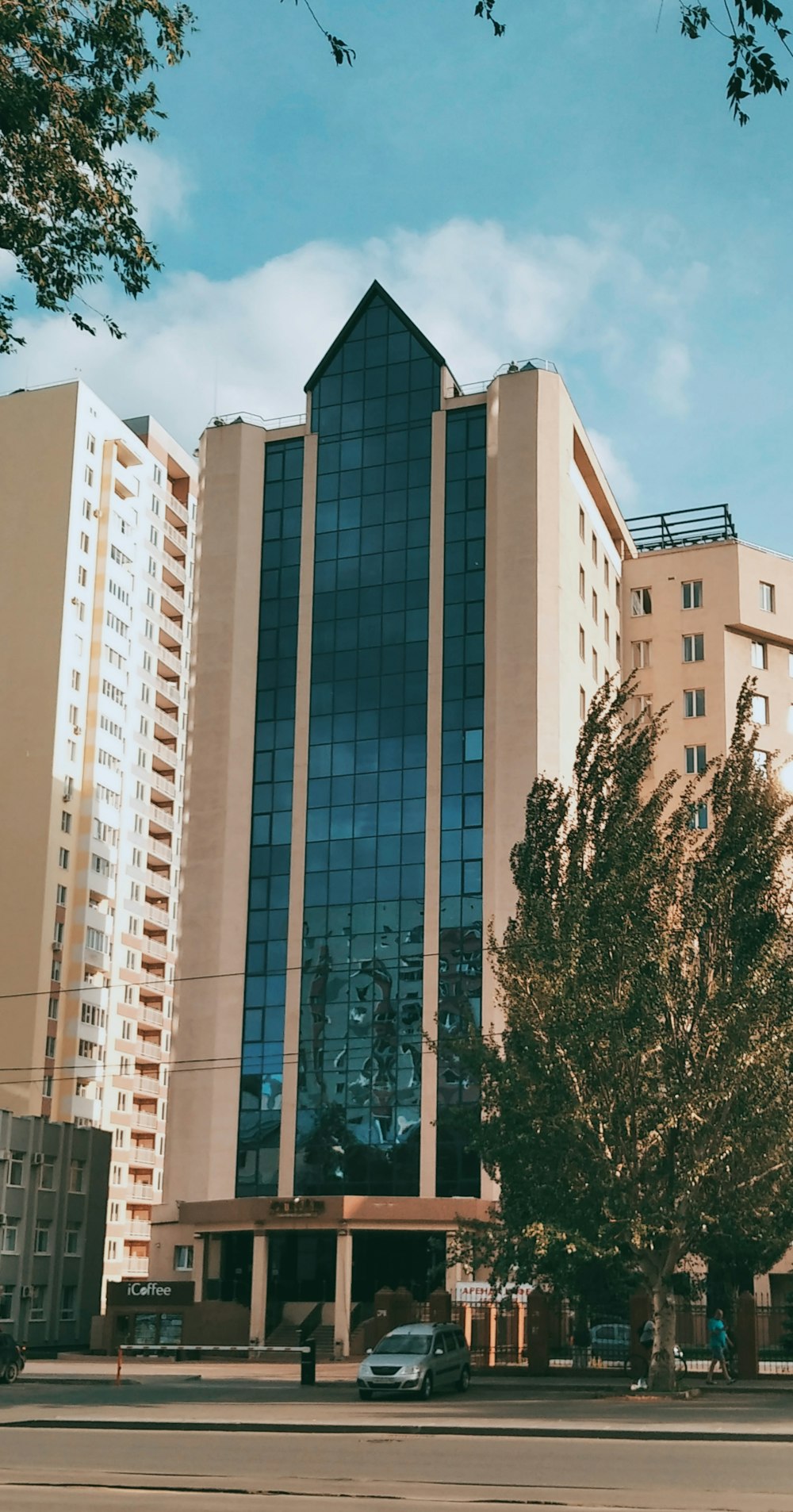 a tall building with a tree in front of it