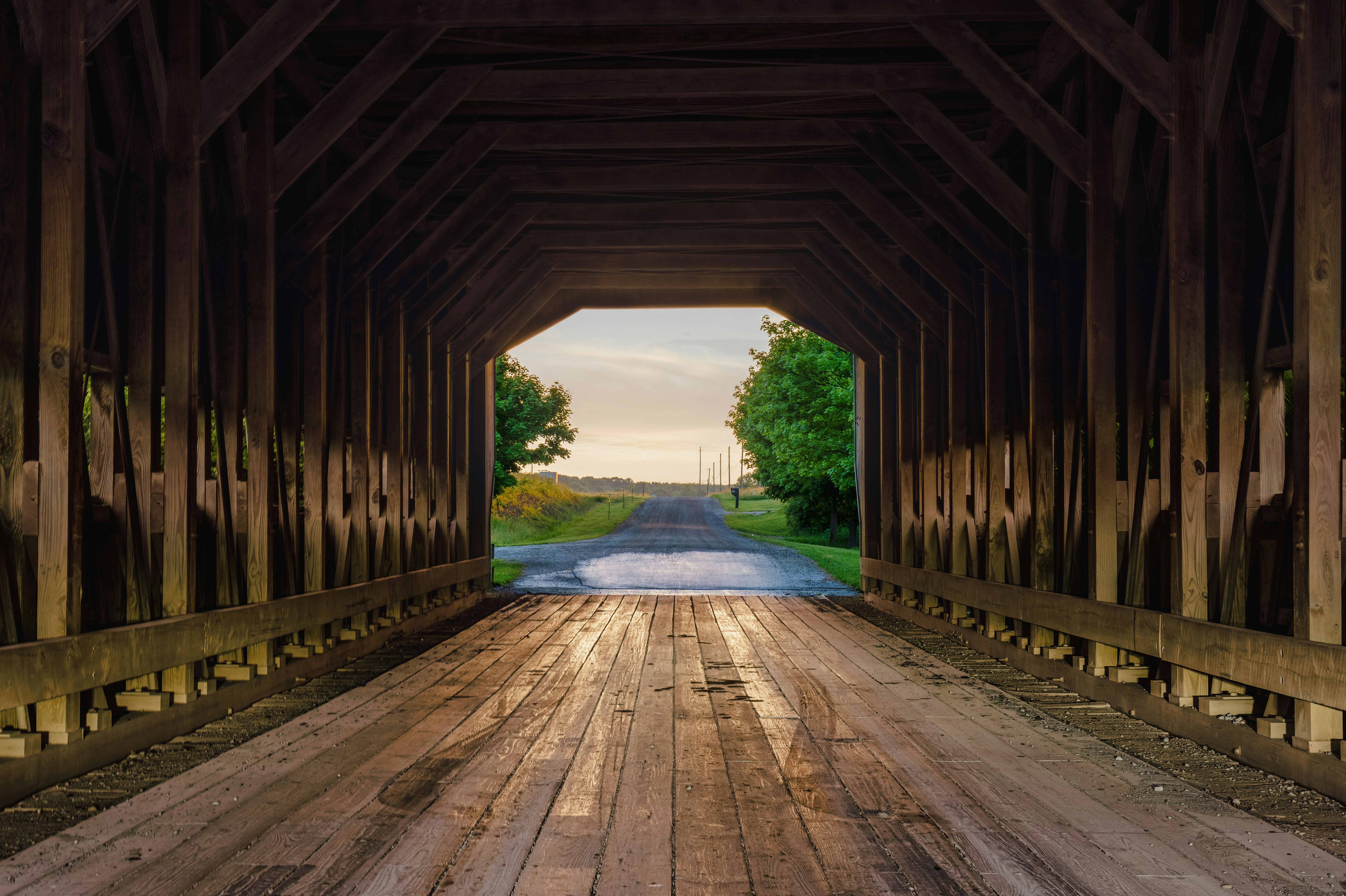 a wooden bridge with a river