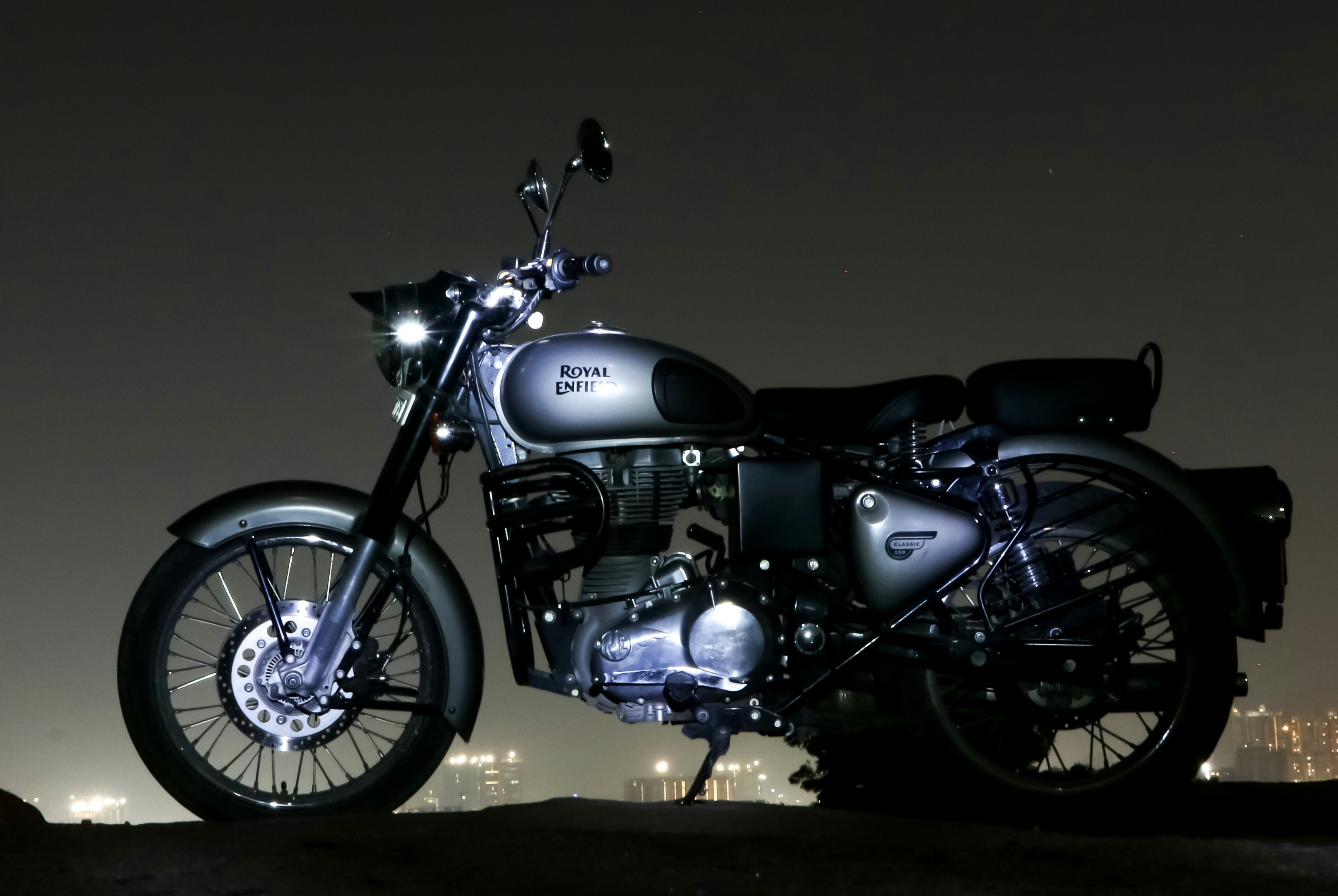 CB650R on urban street at night, city lights background