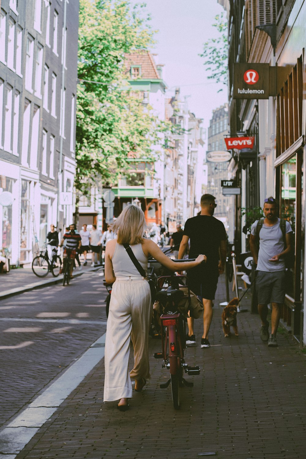 a person riding a bicycle down a sidewalk