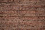 Detailed shot of ancient inscriptions carved in stone.