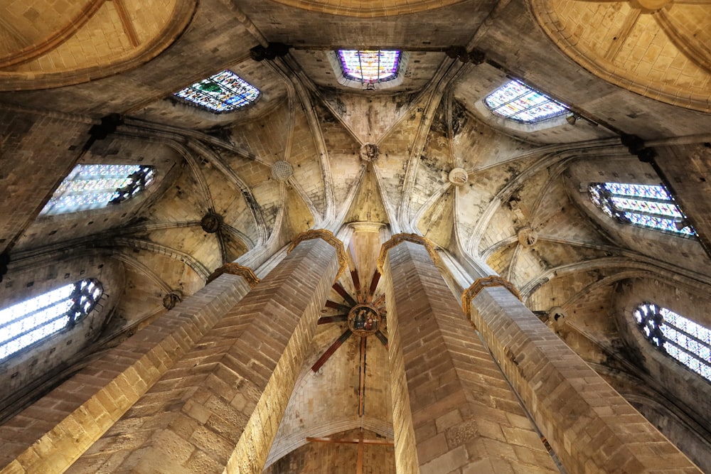 a large wooden ceiling with stained glass windows